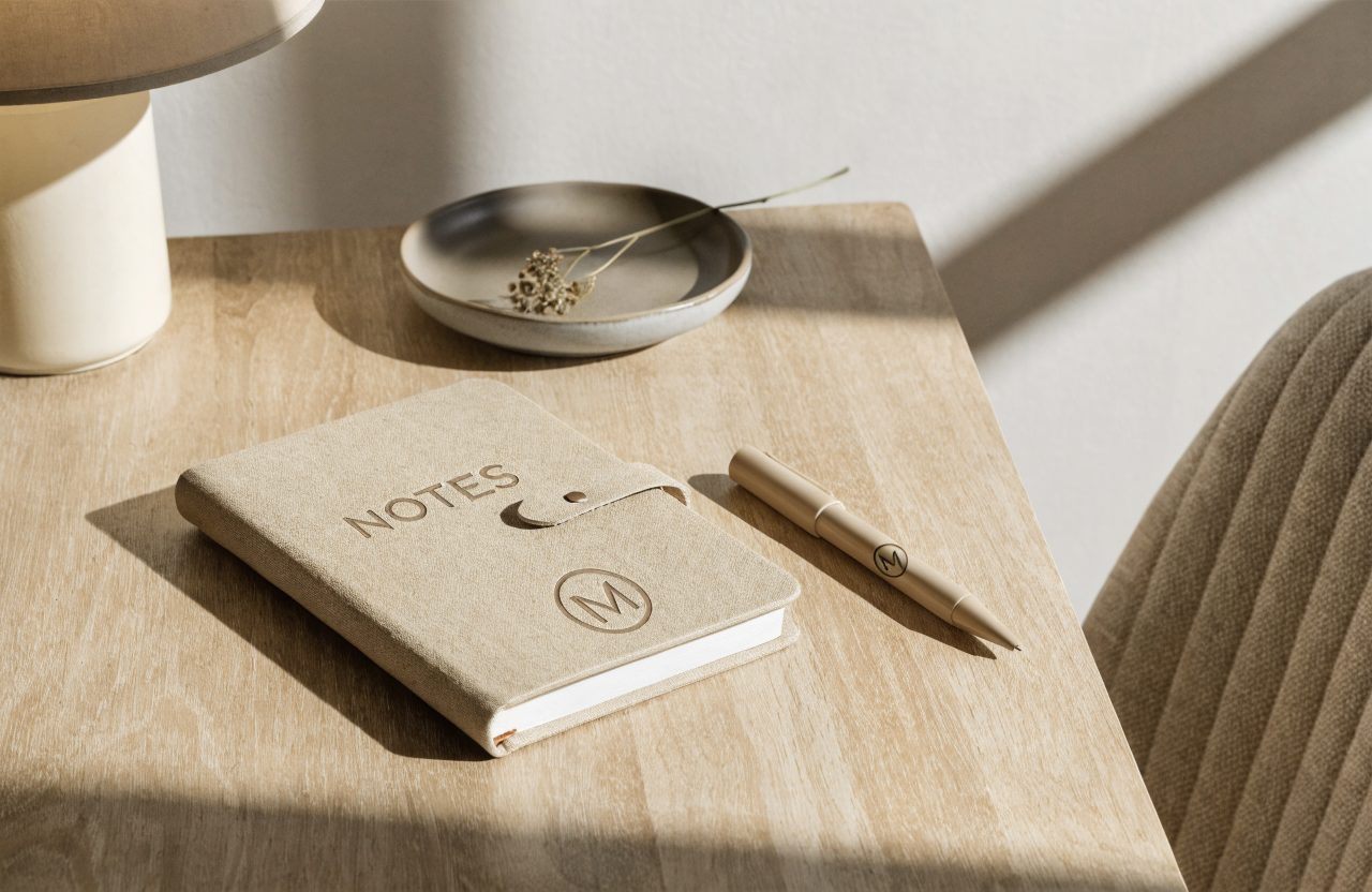 Concept debossed notebook and pen on a desk